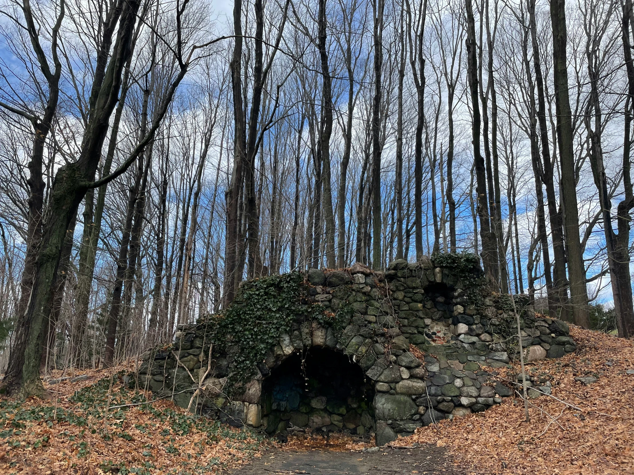 a very big pretty stone tunnel in the middle of the woods