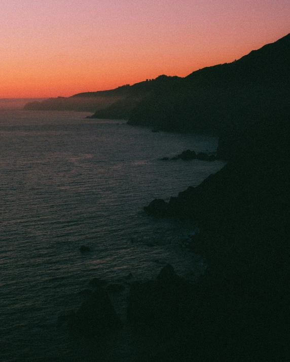 a sunset with a large body of water in the foreground