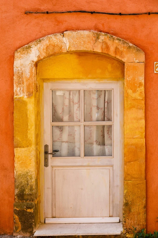 an image of a doorway with glass and yellow walls