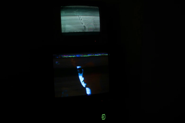 a television with a dark background and two screens showing it's light