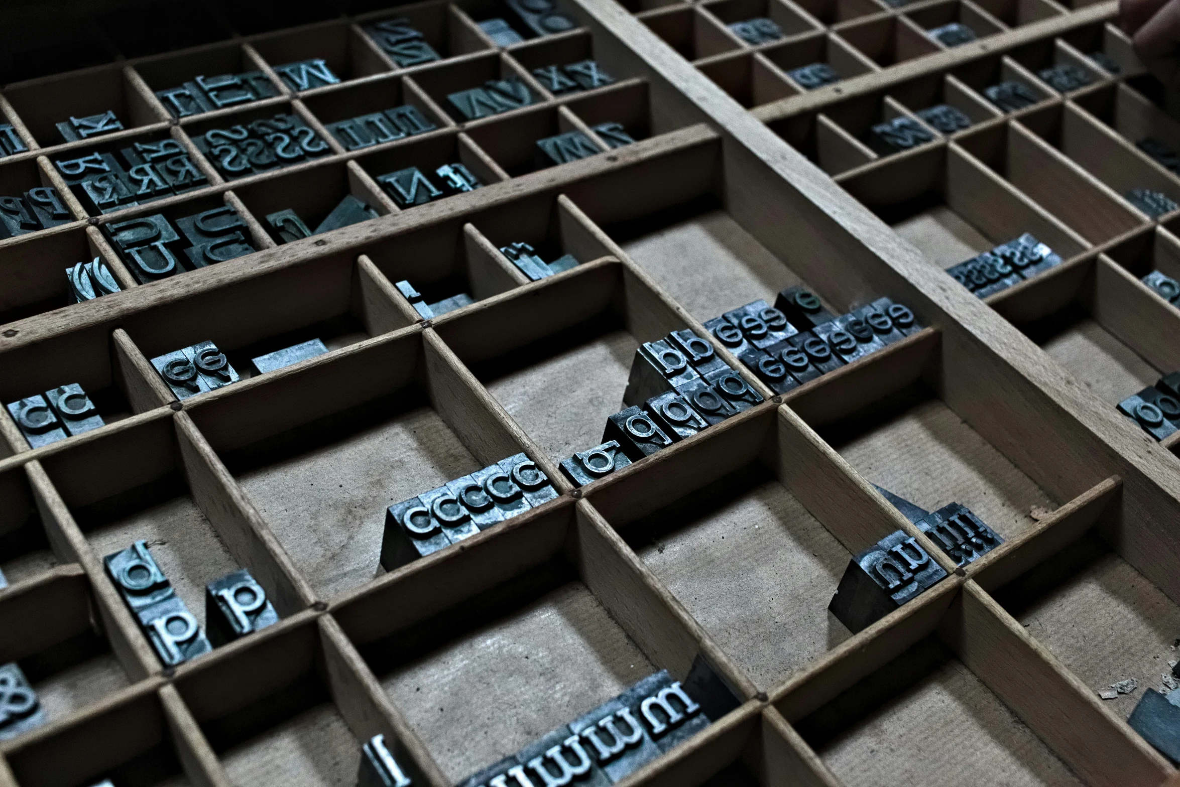 several storage boxes with silver type in them