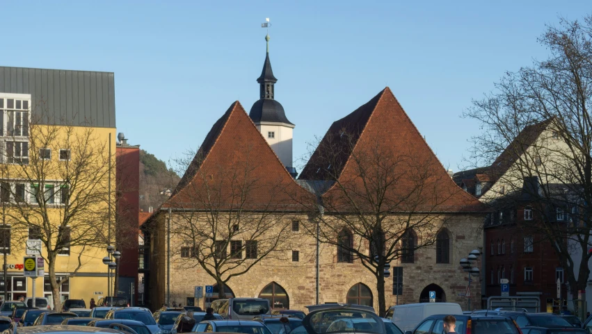 traffic in front of a church with towers and steeples