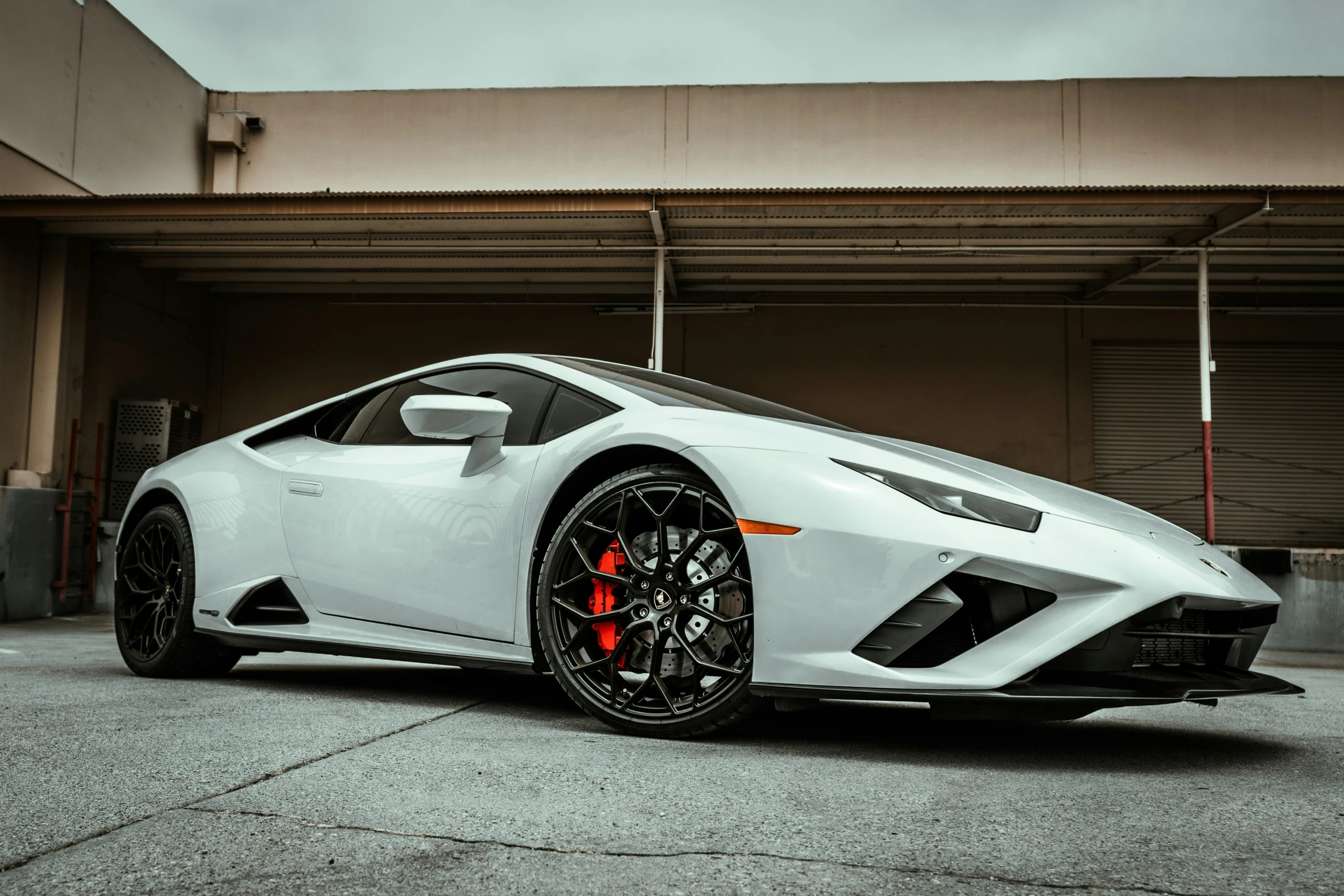 a white car parked next to a building