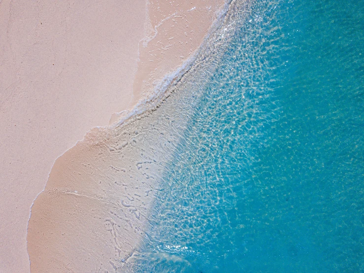 a sea view with sand and water in the foreground