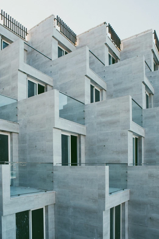 a building with multiple windows sits next to a sky background