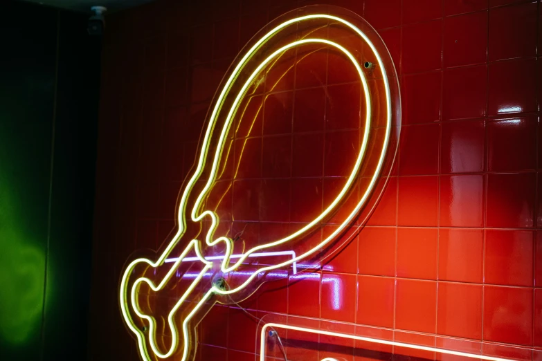 a mirror and light with a neon sign on it