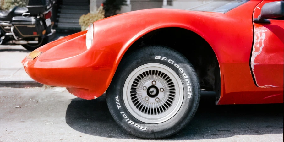 an older sports car sits outside on the street