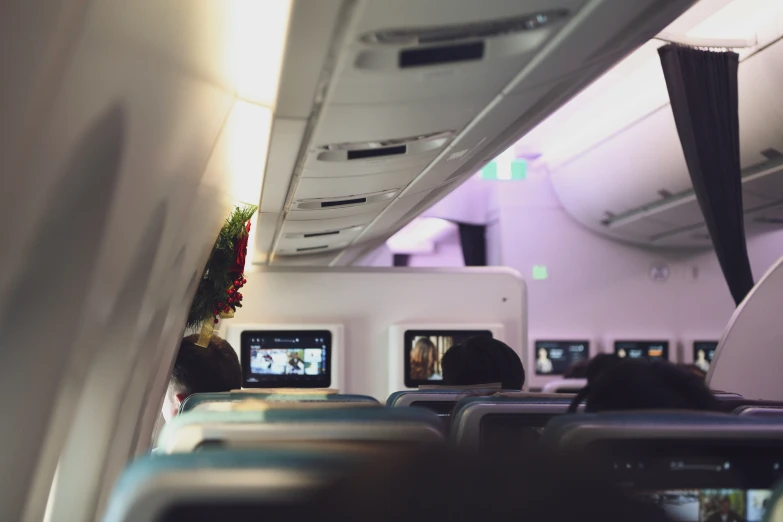 seats and overhead lighting in the middle of a commercial jet