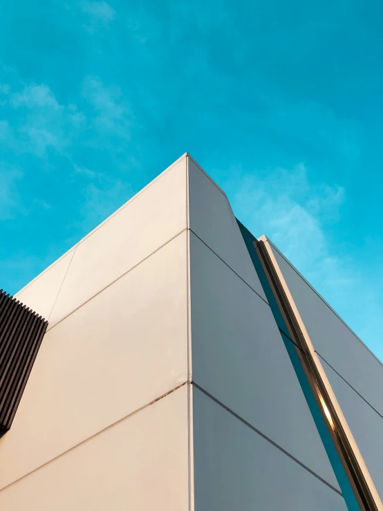 an angled view of a building with a clear blue sky