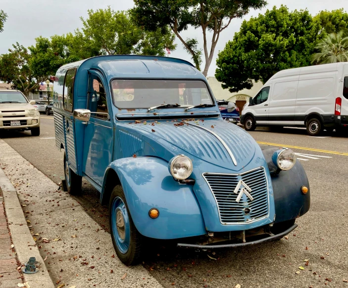 blue antique vw bug driving down the road