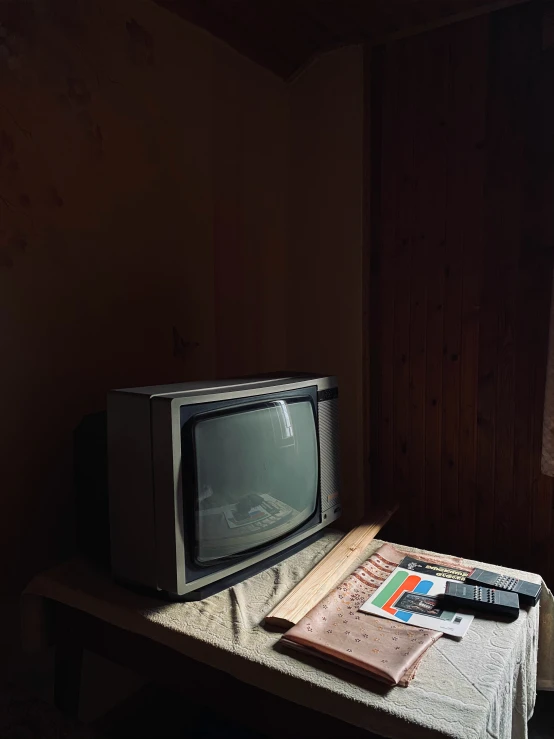 an old television and several other items on a table