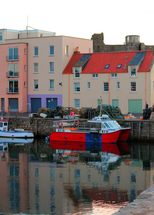 a small boat on a body of water next to houses