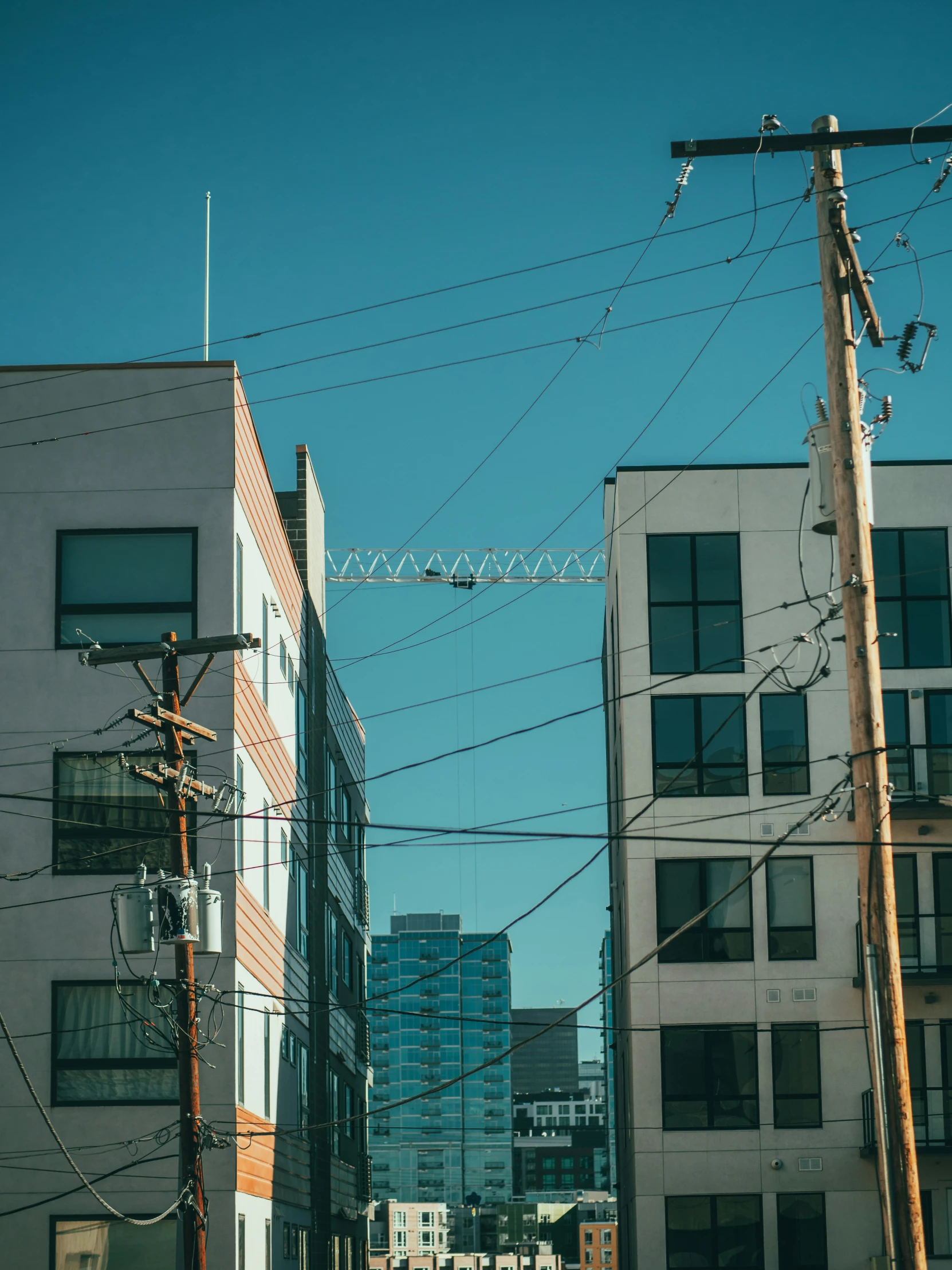 street with power lines in foreground and buildings in background