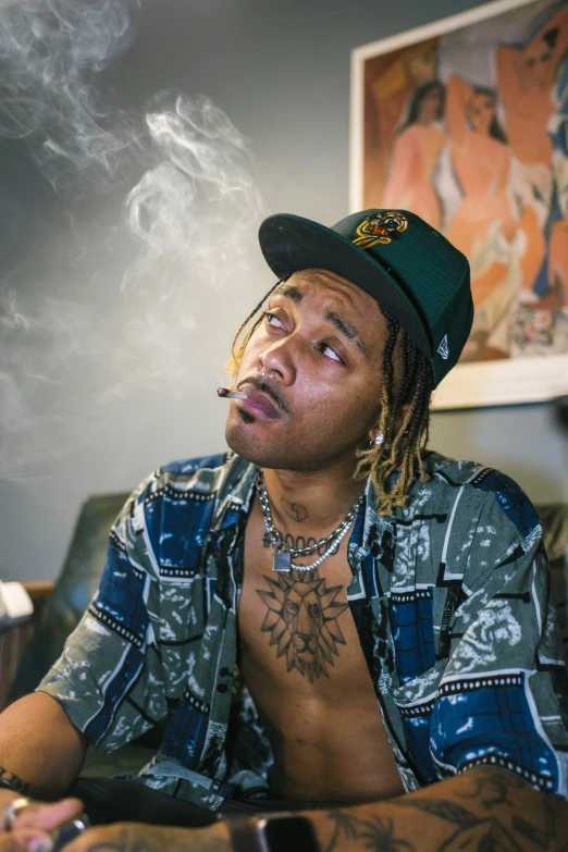 the young man smokes while sitting in a chair