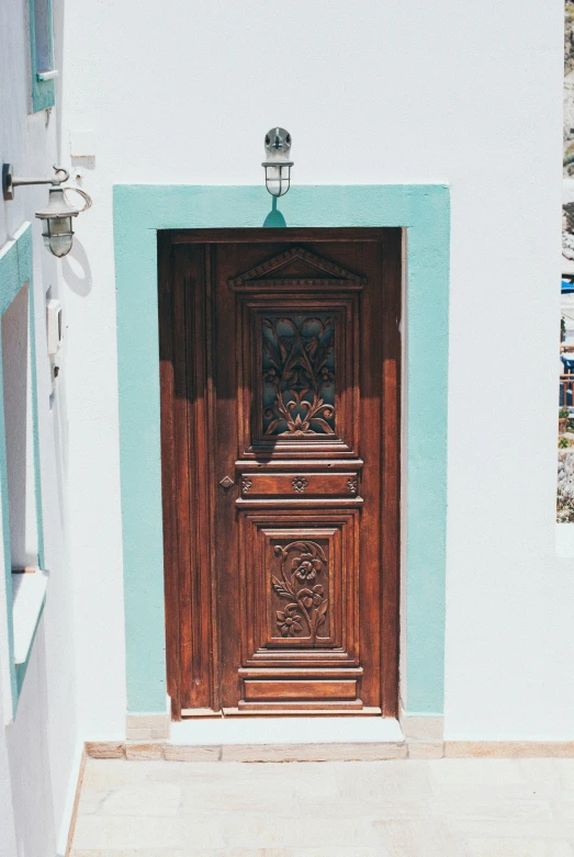 an old wooden door in front of a white building