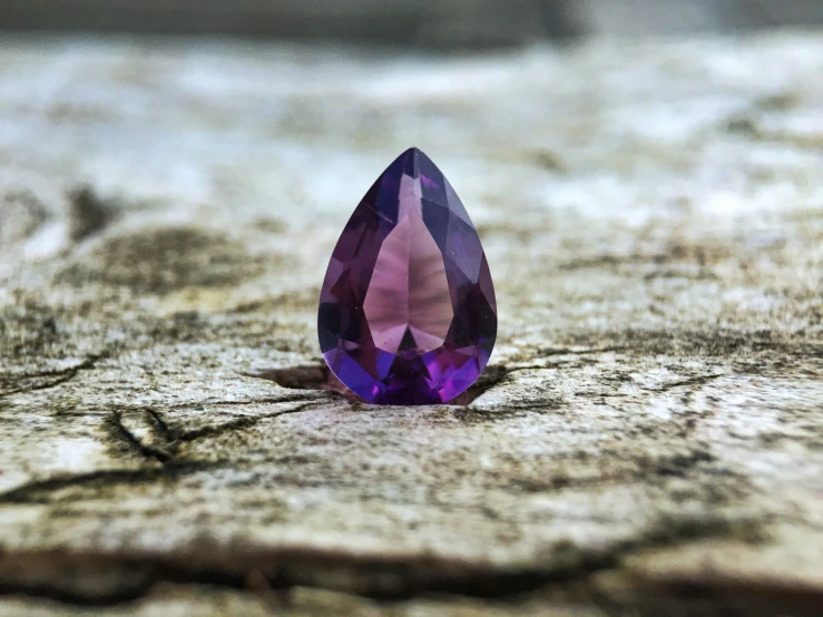 a single ayst stone sitting on top of a wooden board