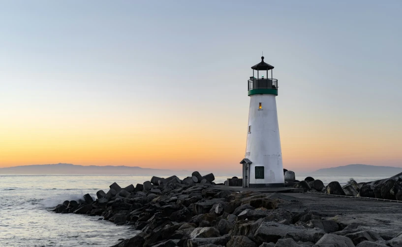 a light house sitting on top of a rocky pier