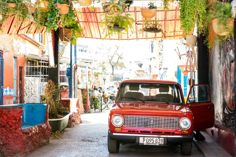 a car parked in a narrow street with buildings