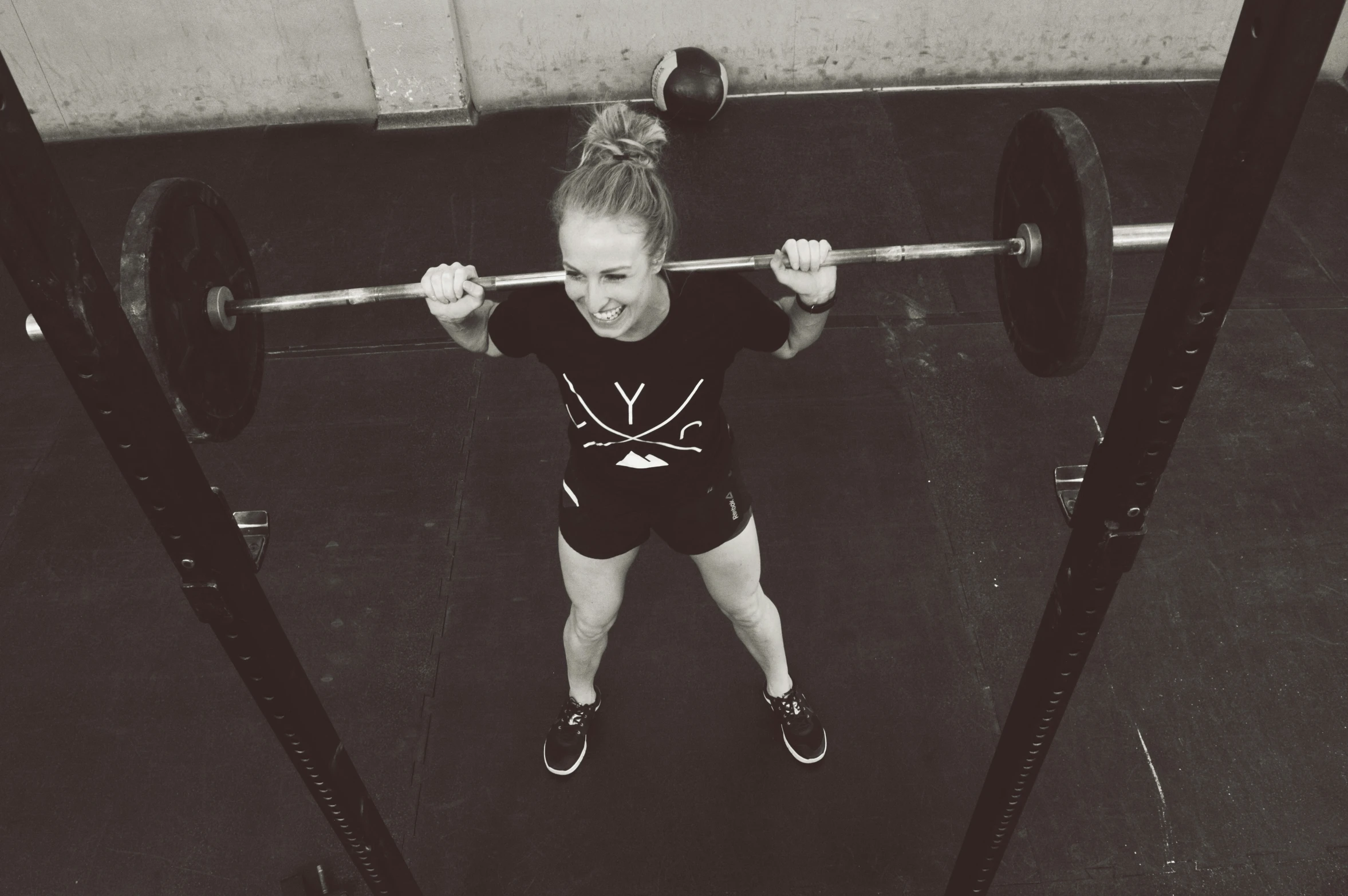 a young person who is performing a deadlift squat