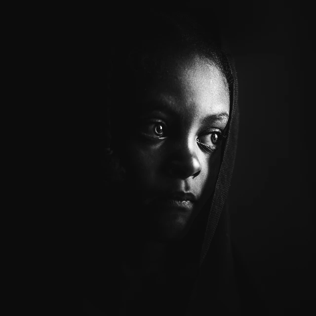 a young woman with bright eyes wearing a hooded hood