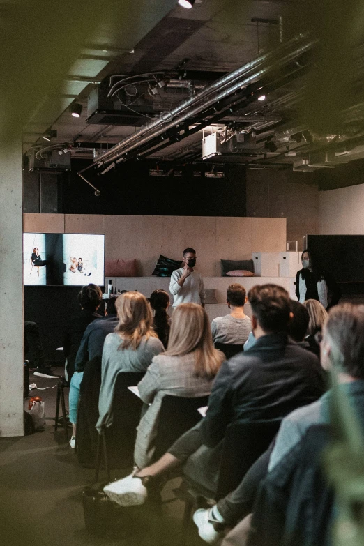 two people giving a lecture to people seated