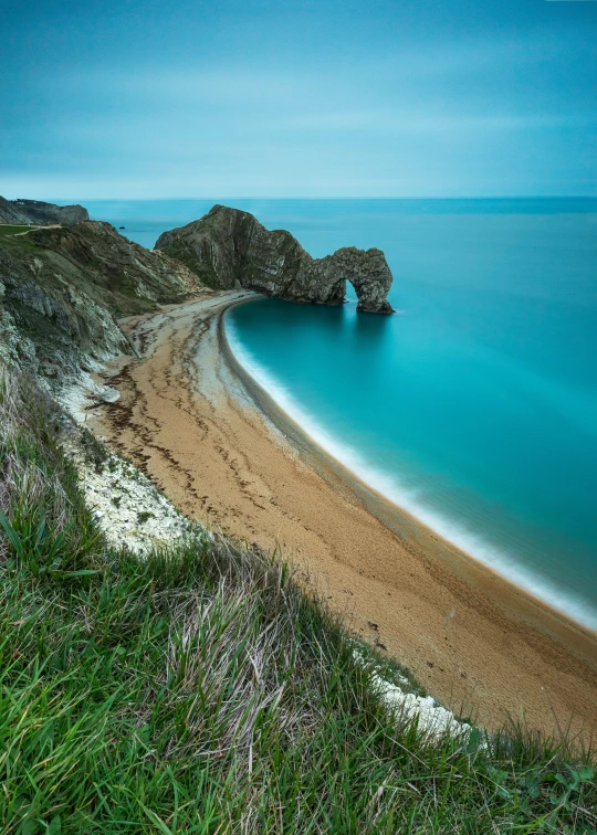 an ocean beach on the coast with waves crashing in