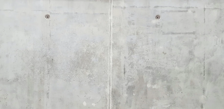 the wall has worn paint as well as holes in it