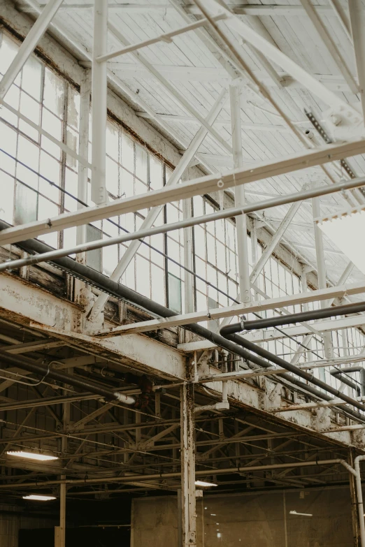 large metal pipes running underneath an industrial building