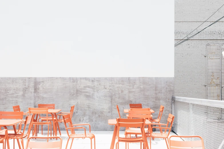 the tables and chairs in the large patio are orange