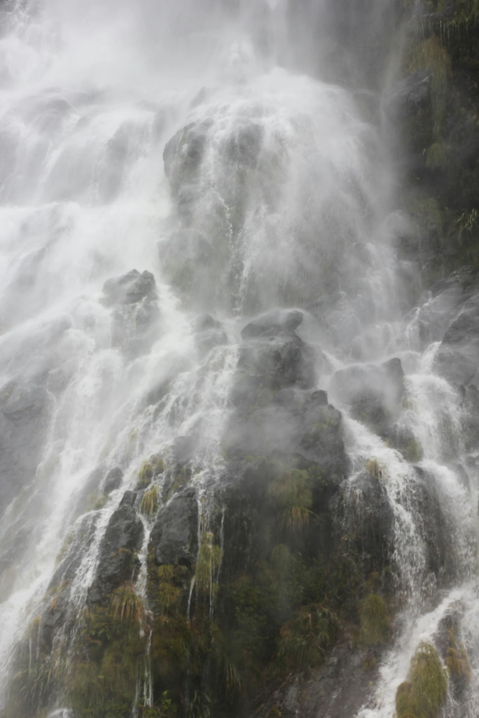 a large waterfall is seen with steam coming from it