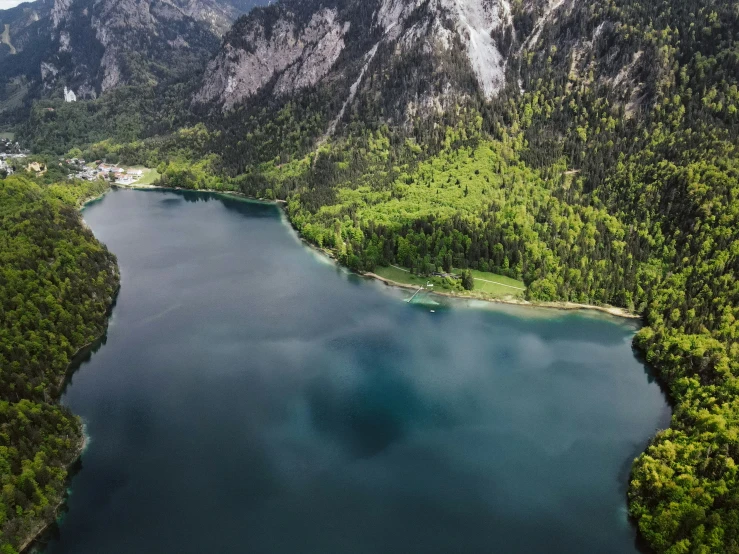 an aerial view of a mountain lake surrounded by forest