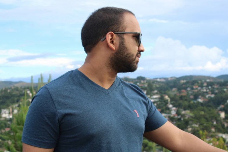 a man wearing glasses and a blue shirt