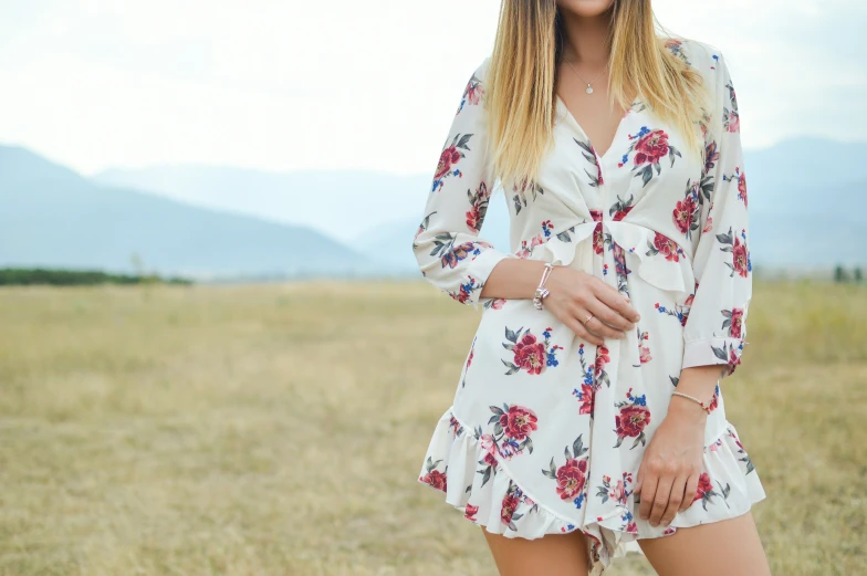 woman in hat and dress posing for a picture