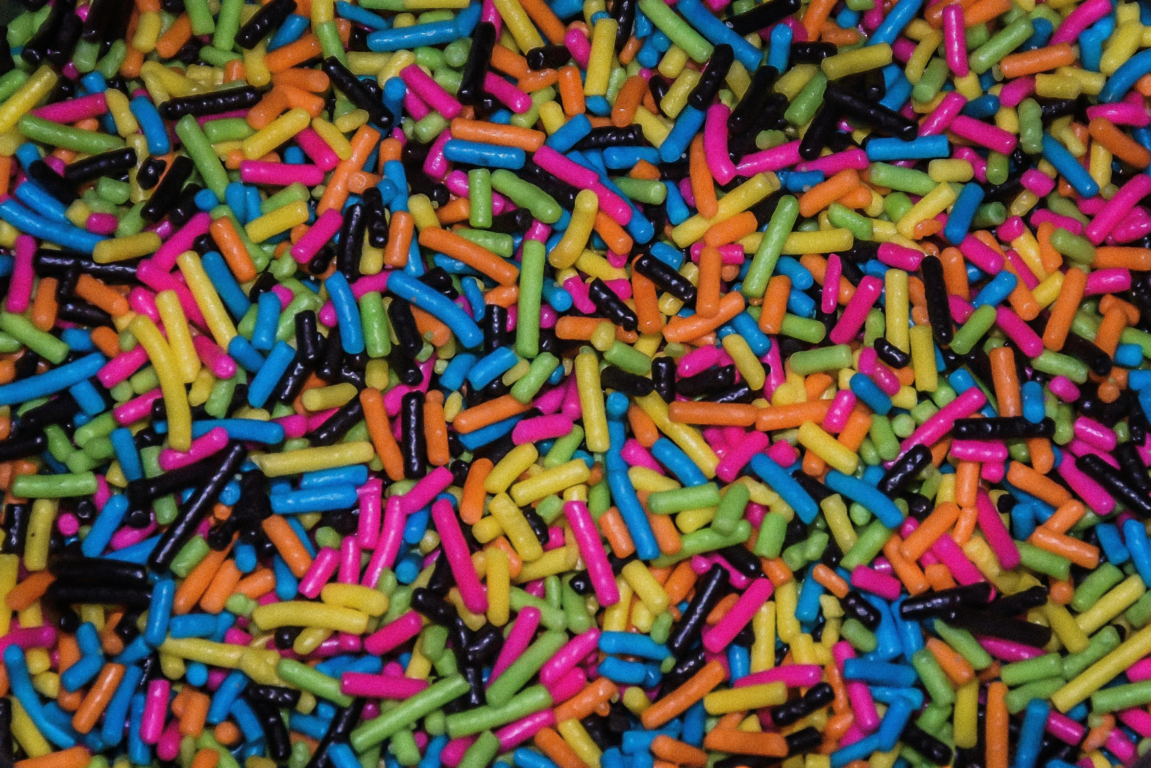 multi - colored sprinkles are scattered and scattered together