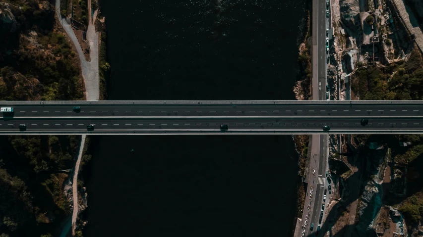 top view of bridge over the river with cars traveling