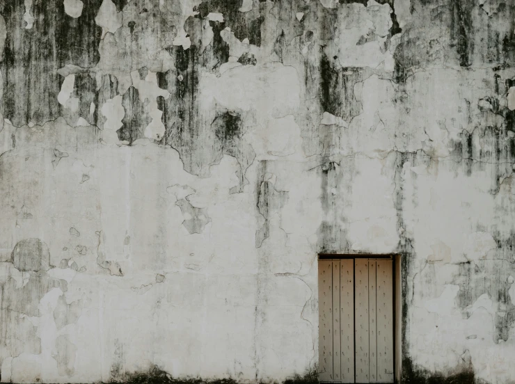 an old and very dirty building with a doorway