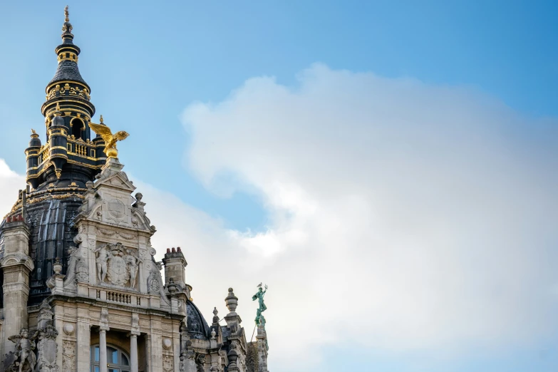 an ornate tower with golden decoration against a clear blue sky