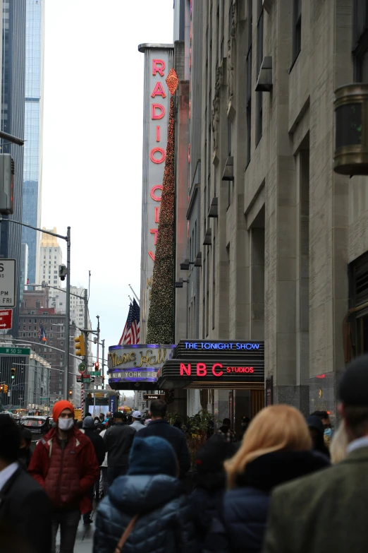 many people are walking around outside on a street