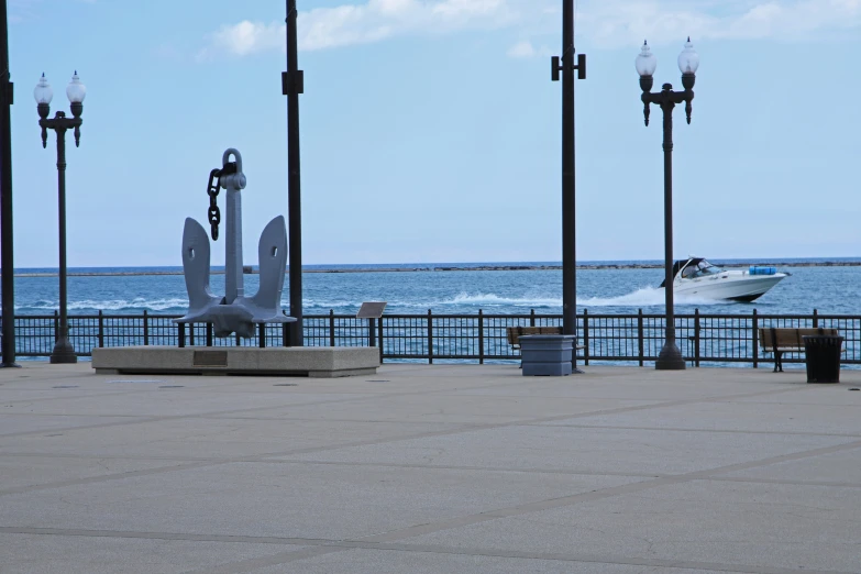 a white boat docked next to lampposts on the waterfront