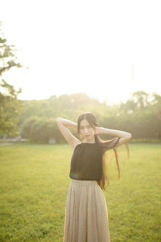 the girl with the long hair is posing for the camera