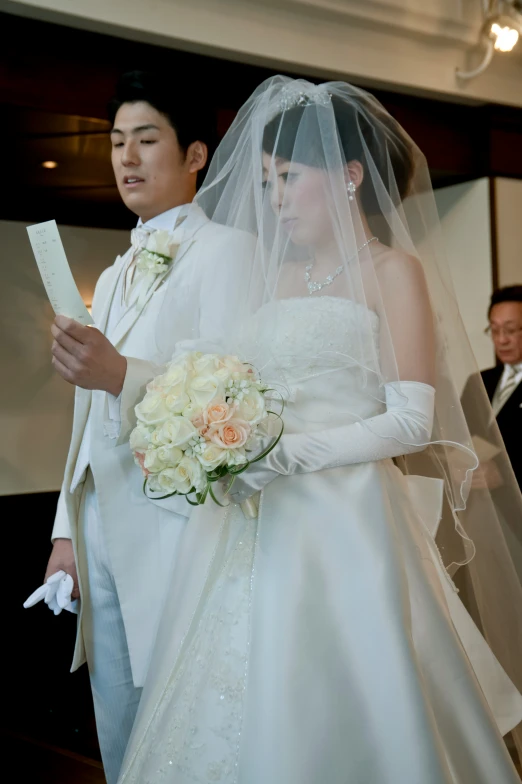 a couple getting married while they have their arms around each other