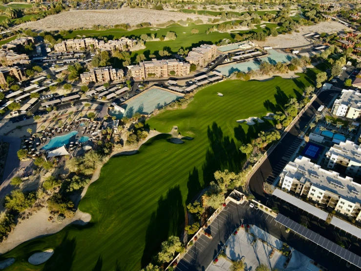 an aerial view of some buildings and golf greens