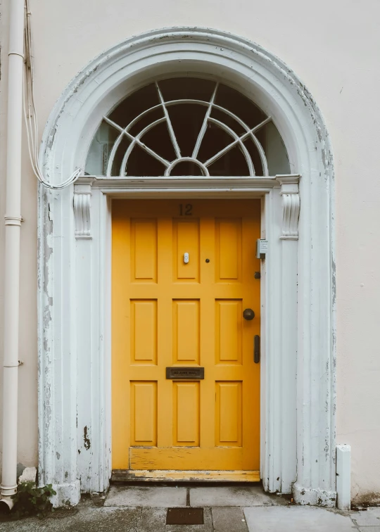 the door is opened on a very big yellow front door