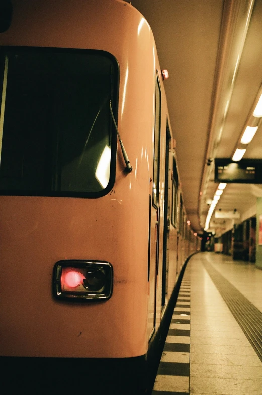a subway train waiting at the platform for passengers