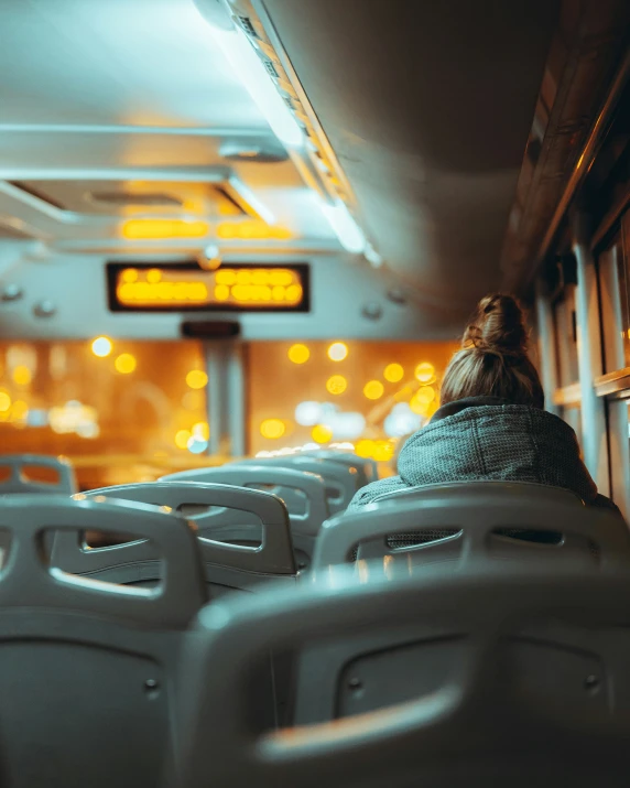 a woman is on a train with her head turned