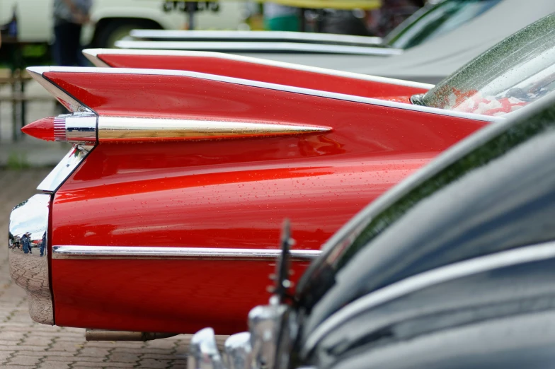 several classic classic red cars parked side by side