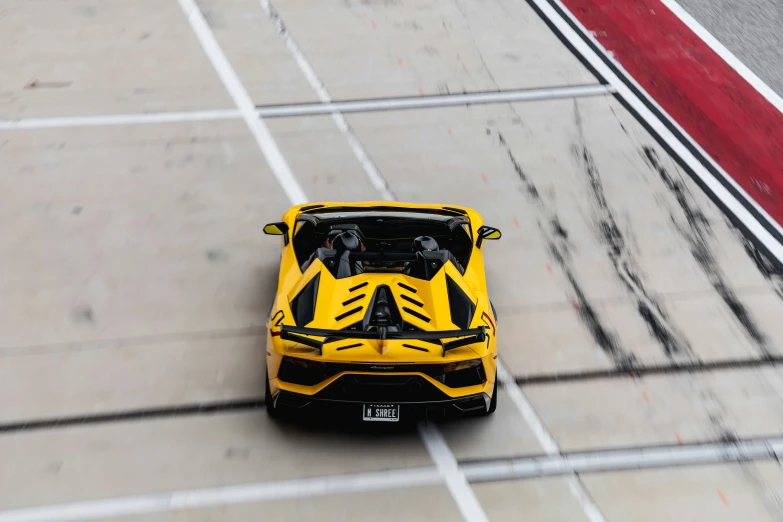 a car is on the track in a racing suit