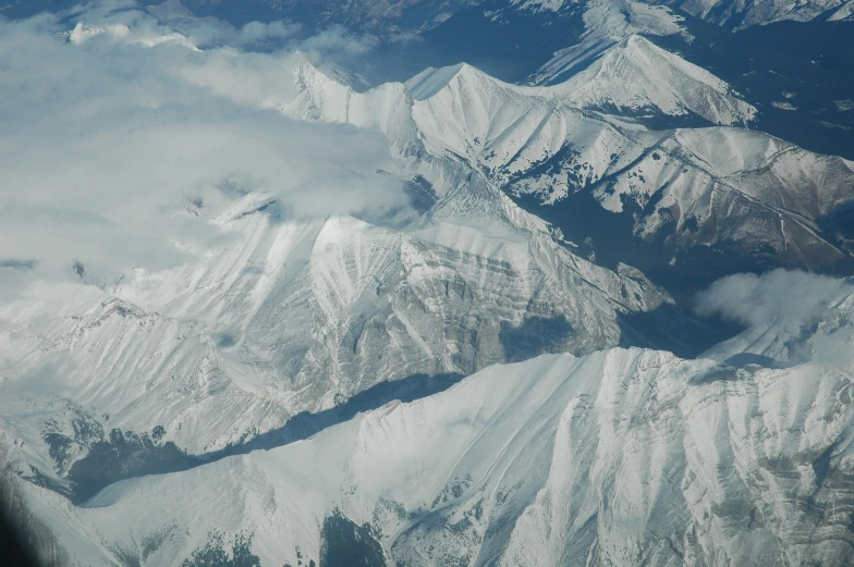 a large mountain range with snow covered mountains