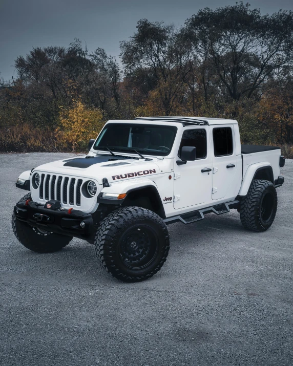 a white jeep truck parked in a parking lot