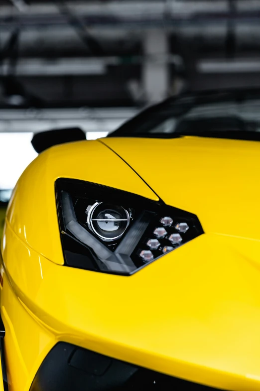 the front of a yellow sports car, close up